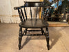 a beautiful early antique ebonised elbow captains chair
