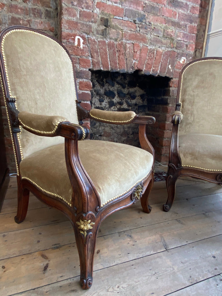 exceptional pair of french empire walnut chairs arm chairs with gilt ormolu mounts