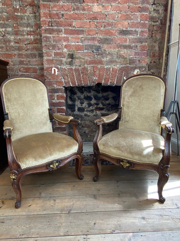 exceptional pair of french empire walnut chairs arm chairs with gilt ormolu mounts