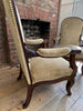 exceptional pair of french empire walnut chairs arm chairs with gilt ormolu mounts